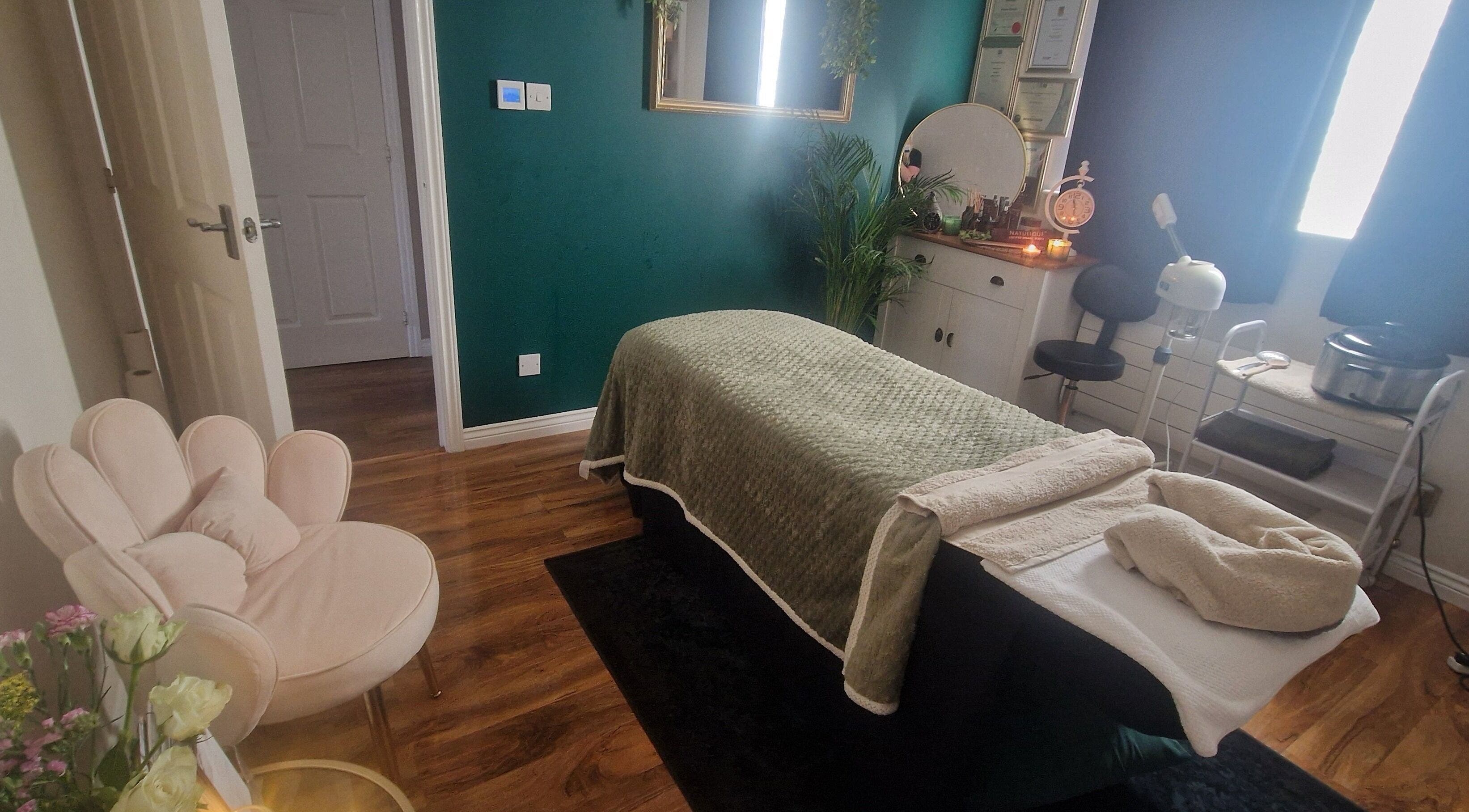 Serene treatment room at Human Balance in Glasgow, Scotland, GB, featuring a massage table and cozy decor.