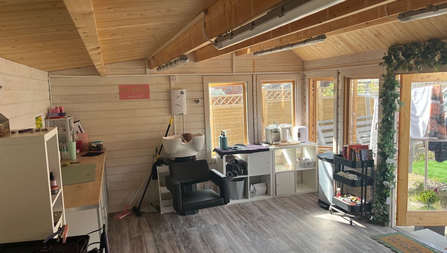 Comfortable interior at Mrs Mabbley Hair Studios in Aldershot, England, GB with styling stations and natural light.