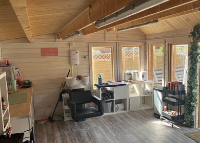Comfortable interior at Mrs Mabbley Hair Studios in Aldershot, England, GB with styling stations and natural light.