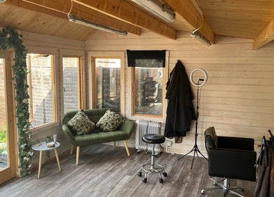 Cozy interior of Mrs Mabbley Hair Studios, Aldershot, England, GB featuring modern seating and decor.