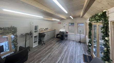 Chic interior of Mrs Mabbley Hair Studios, Aldershot, England, GB, featuring sleek decor and modern salon equipment.