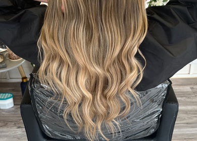 Long wavy blonde hair styled at Mrs Mabbley Hair Studios, Aldershot, England, GB.