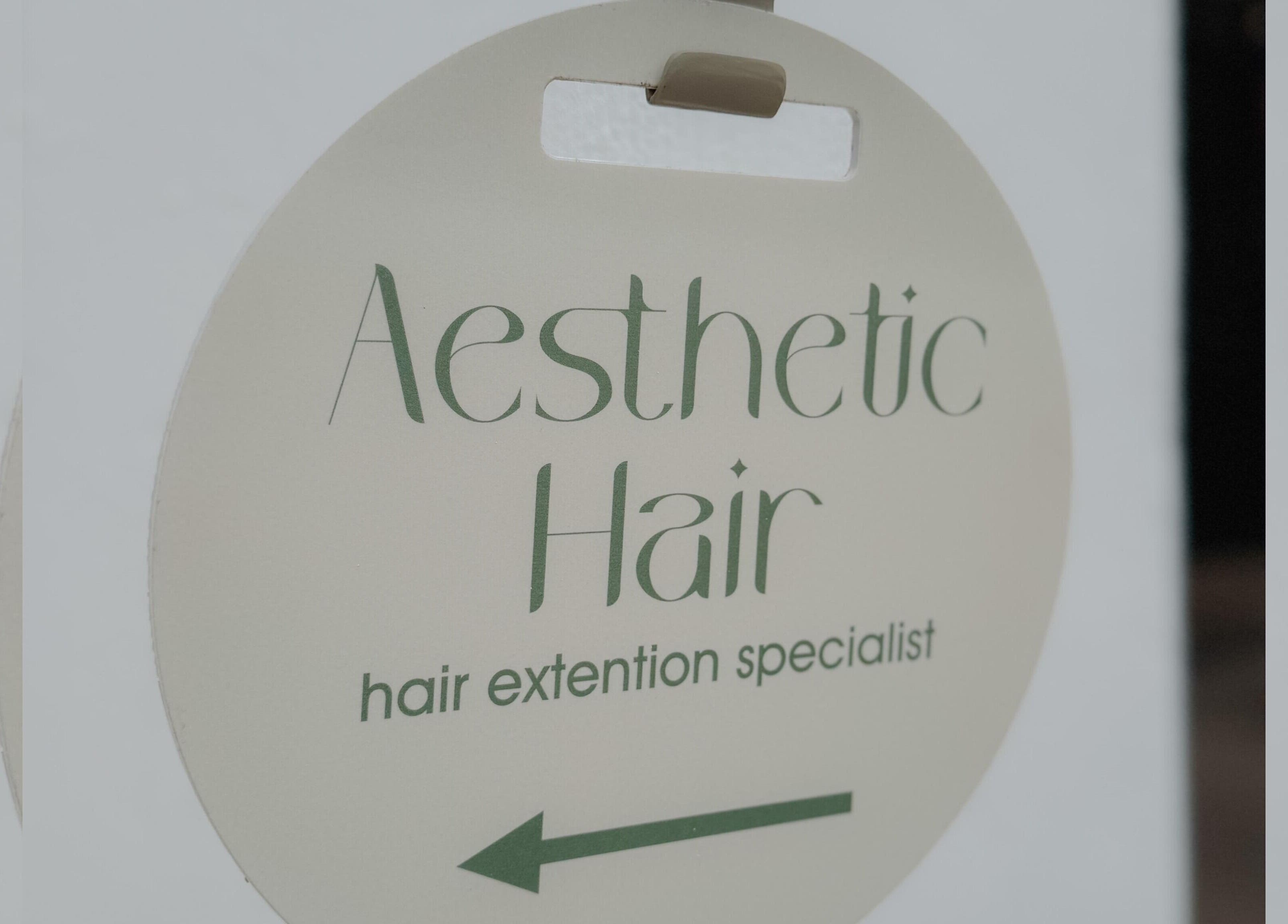 Aesthetic Hair signboard at Stellenbosch, Western Cape, ZA, displaying hair extension services.