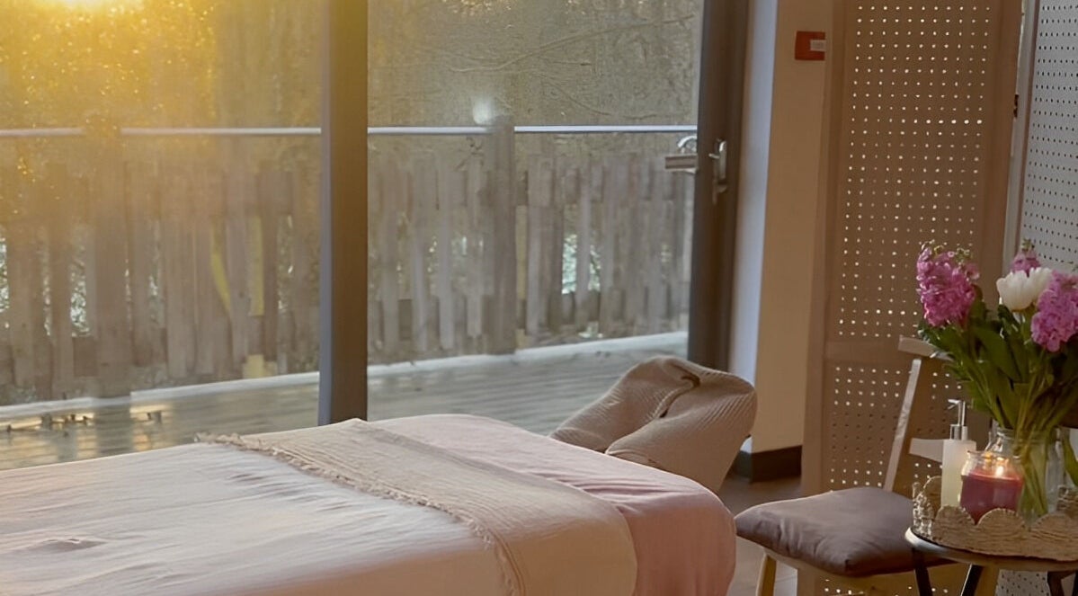 Relaxing massage setup at New Chapter Massage at Larchwood Studio, Hay-on-wye, Wales, GB, bathed in warm sunlight.