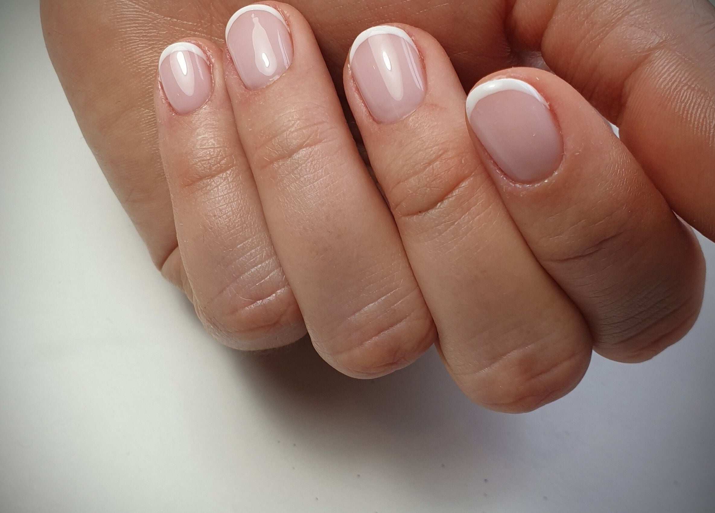 French manicure at Chique Nail Studio, London, England, GB offering sophisticated nail designs.