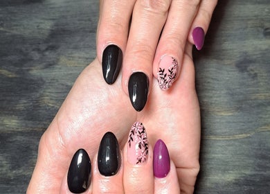 Elegant floral nail art at Ninnie's, Boksburg, Gauteng, ZA. Black and pink manicure with intricate designs.