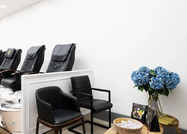 Elegant pedicure chairs and blue flowers at Perfect Image Nails, London, England, GB.