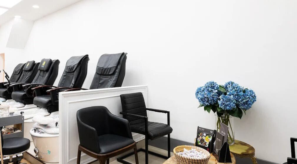 Elegant pedicure chairs and blue flowers at Perfect Image Nails, London, England, GB.