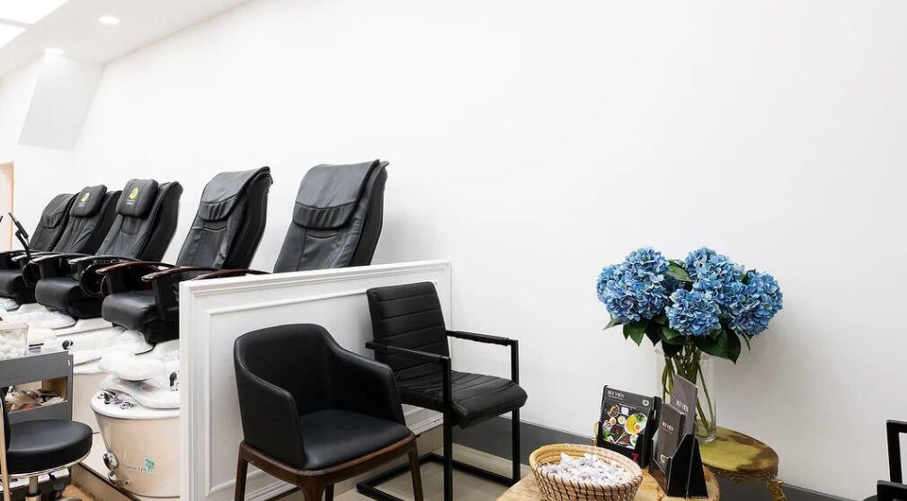 Elegant pedicure chairs and blue flowers at Perfect Image Nails, London, England, GB.