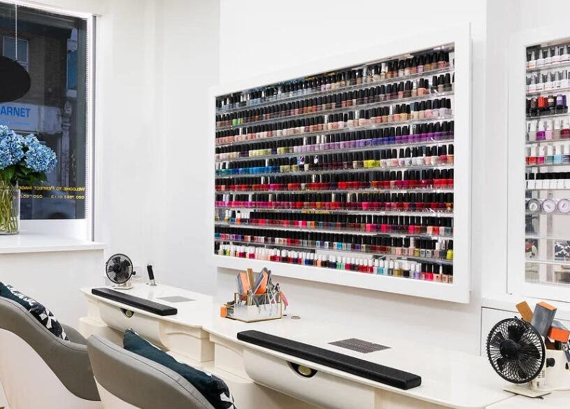 Wall of nail polishes at Perfect Image Nails, a chic nail salon in London, England, GB.