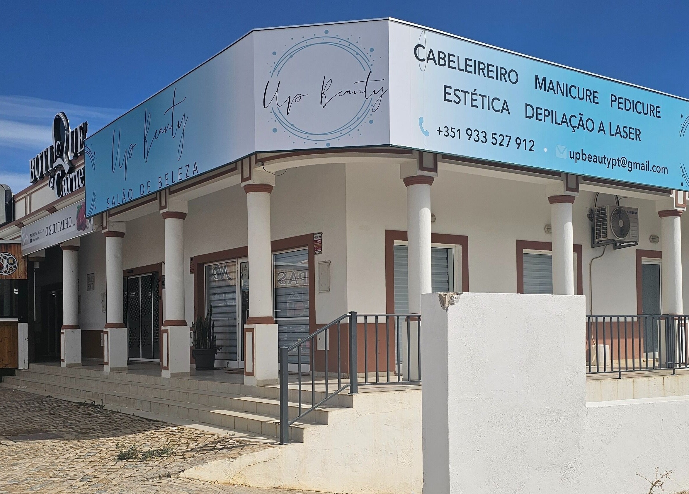 Fachada do Upbeautysalon em Albufeira, Faro, PT, destacando entradas e sinalética do salão de beleza.