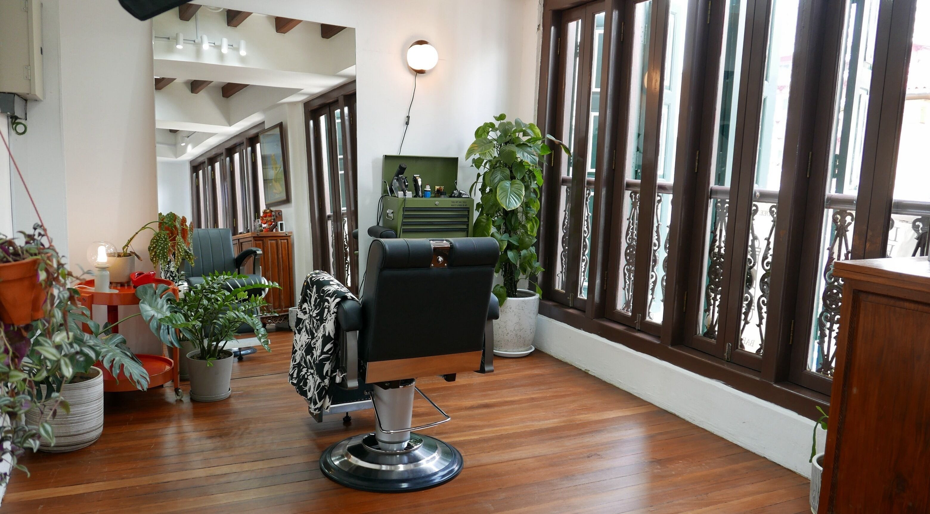 Elegant salon interior at DEE YONDER PTE LTD, Singapore, Singapore, SG, with plush chair and greenery.