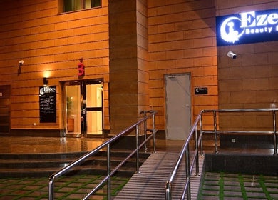 Illuminated entrance of Ezees Beauty & Spa in Al Khobar, Eastern Province, SA, showcasing modern design.