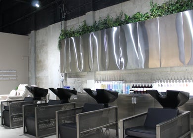 Modern wash stations at Paintbox Hair Studio in Dubai, Dubai, AE with sleek design and industrial decor.