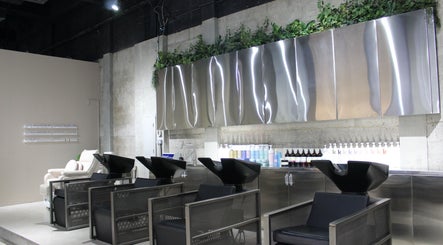 Modern wash stations at Paintbox Hair Studio in Dubai, Dubai, AE with sleek design and industrial decor.