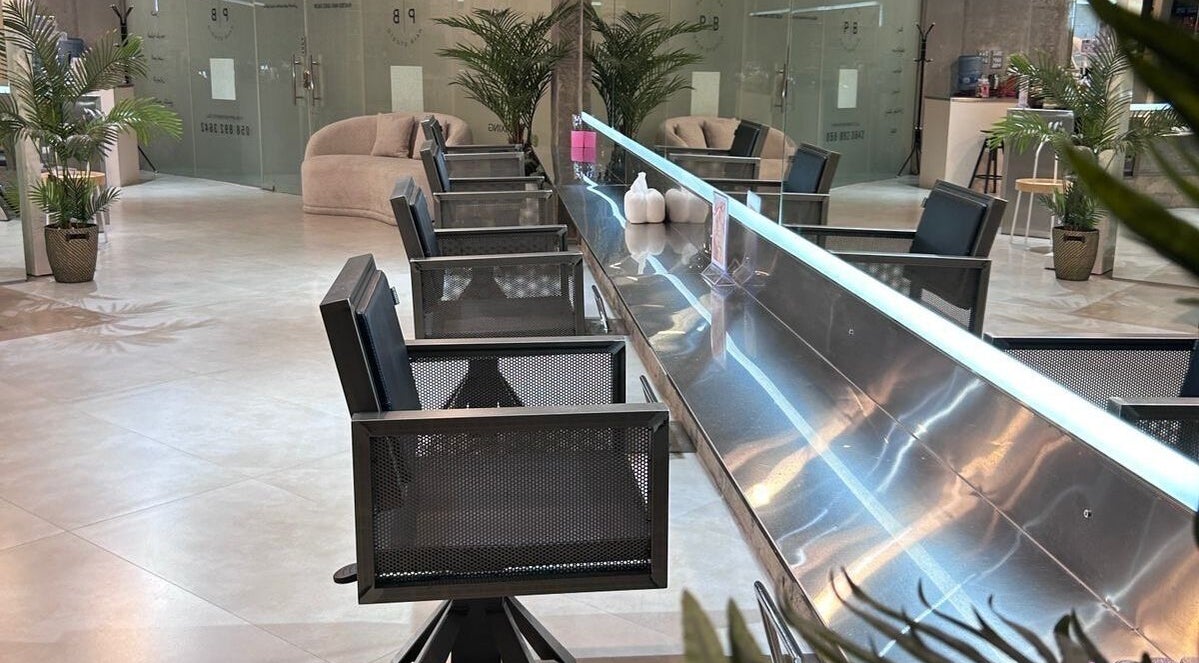 Modern styling chairs and elegant decor at Paintbox Hair Studio, Dubai, Dubai, AE, showcasing sleek design.