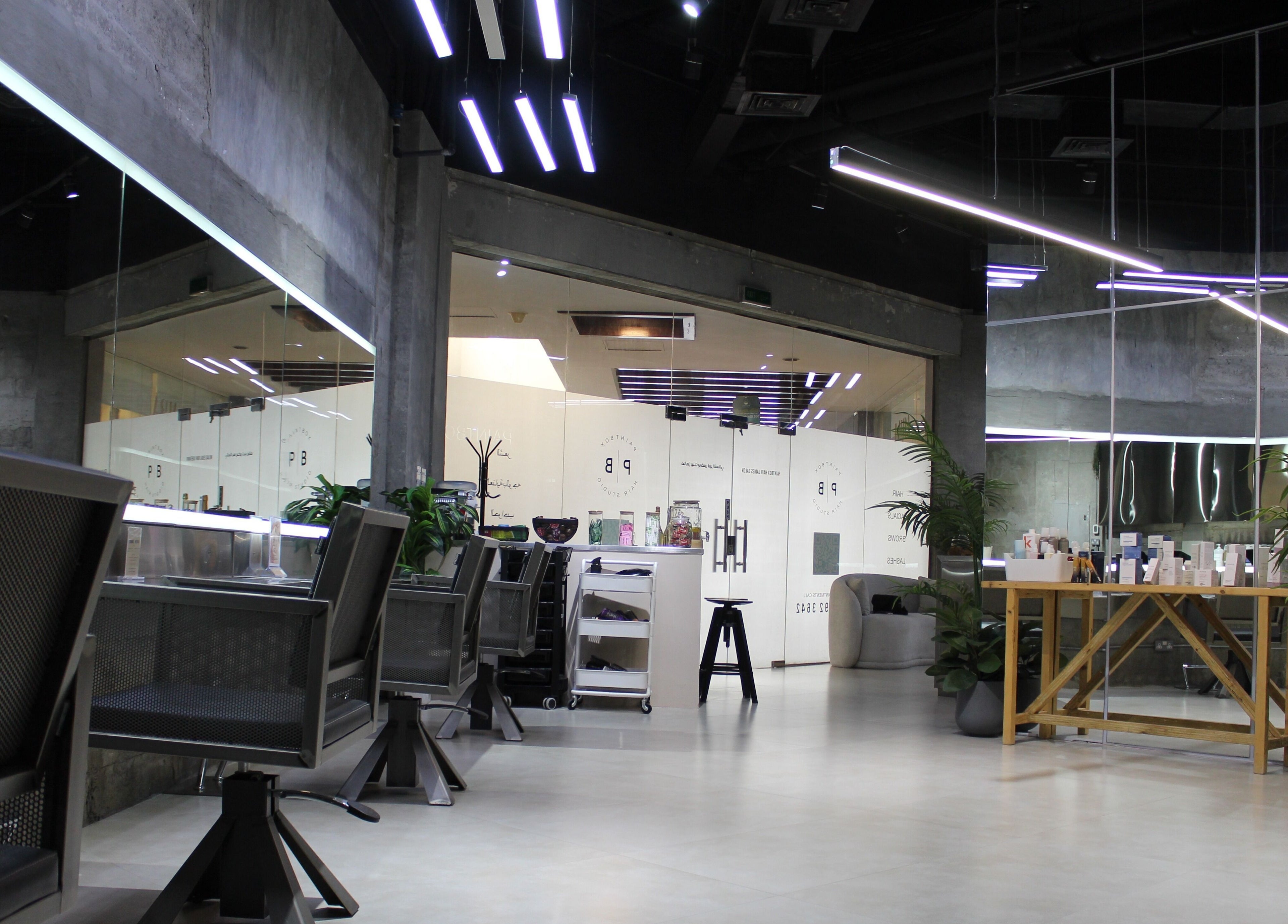Modern interior of Paintbox Hair Studio in Dubai, Dubai, AE showcasing sleek design and stylish seating.