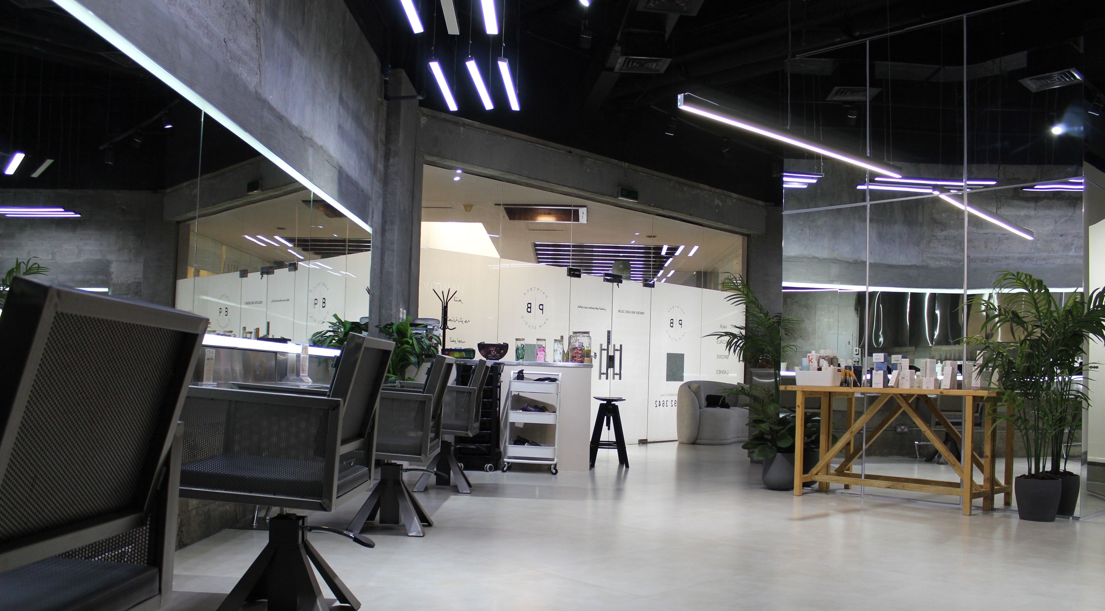 Modern interior of Paintbox Hair Studio in Dubai, Dubai, AE showcasing sleek design and stylish seating.