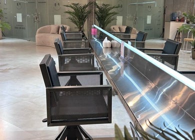 Interior of Paintbox Hair Studio in Dubai, Dubai, AE with modern chairs and elegant decor.
