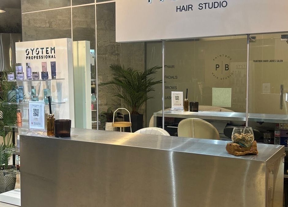 Reception area of Paintbox Hair Studio in Dubai, Dubai, AE showcasing stylish decor and products.