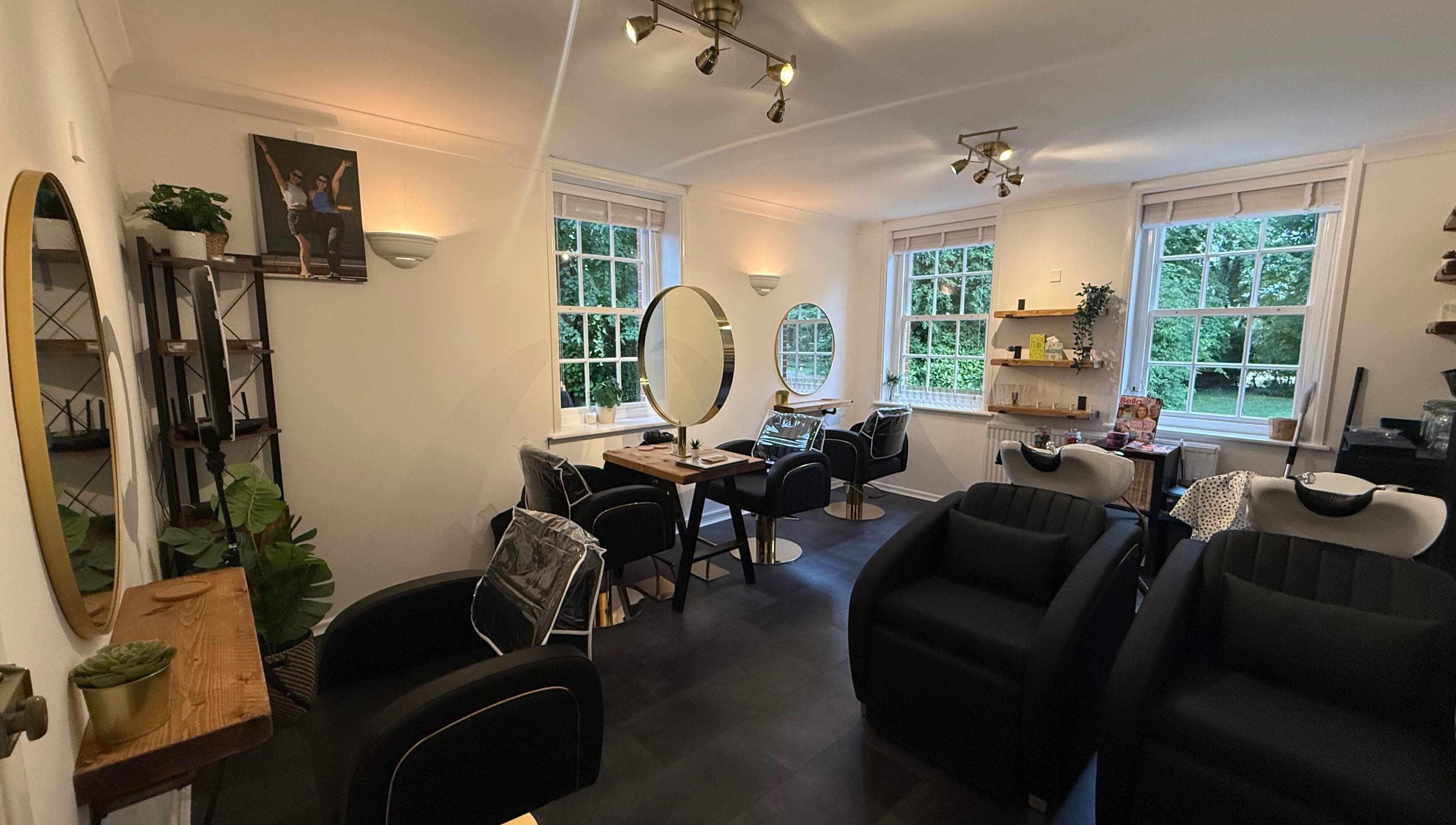 Chic interior of Hair By Milly Rose, Basingstoke, England, GB with modern salon chairs and mirrors.