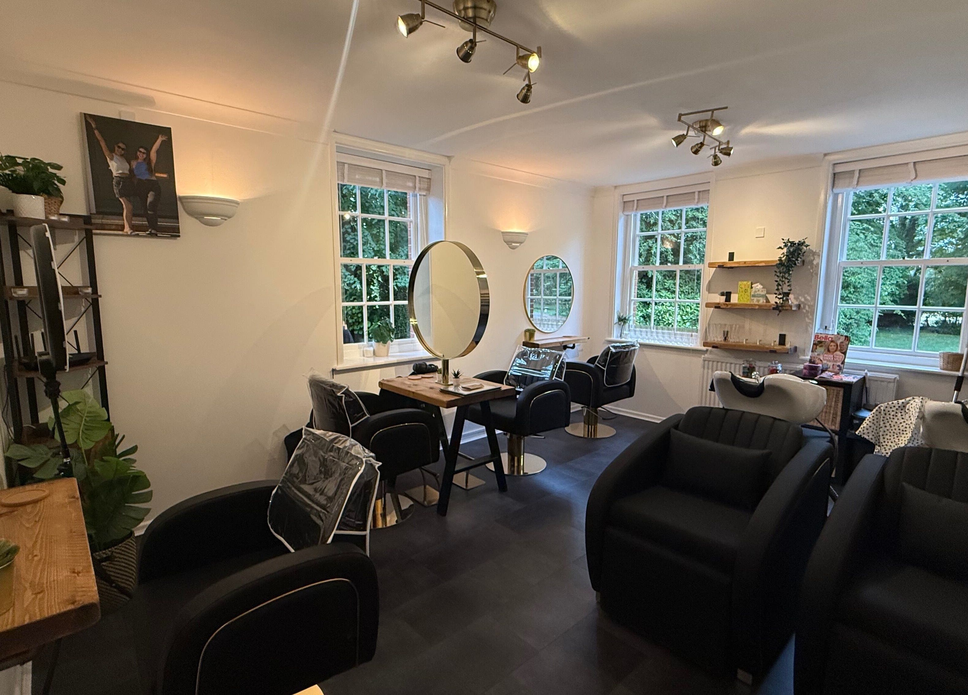 Chic interior of Hair By Milly Rose, Basingstoke, England, GB with modern salon chairs and mirrors.