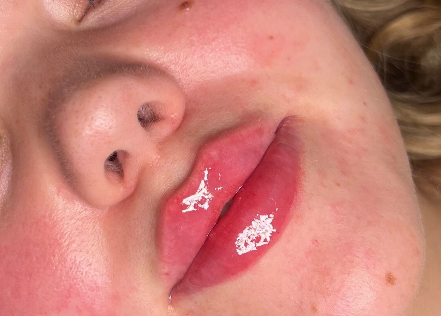 Close-up of glossy lips post-treatment at By Amelia, Thurmaston, England, GB. Highlighting beautiful shine.