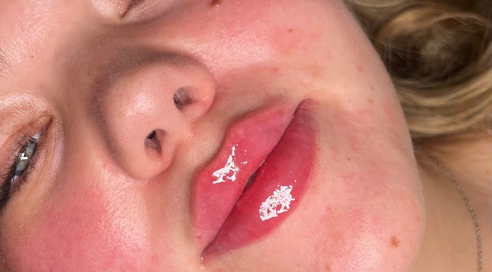 Close-up of glossy lips post-treatment at By Amelia, Thurmaston, England, GB. Highlighting beautiful shine.