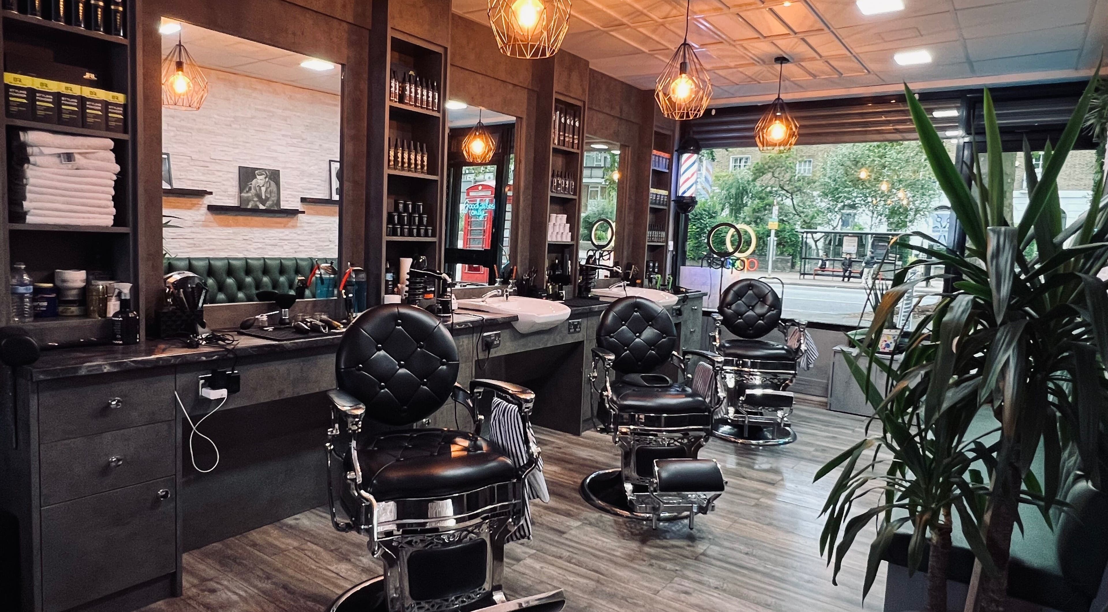 Stylish interior of London Gents Barbers, featuring classic chairs and ambient lighting, London, England, GB.