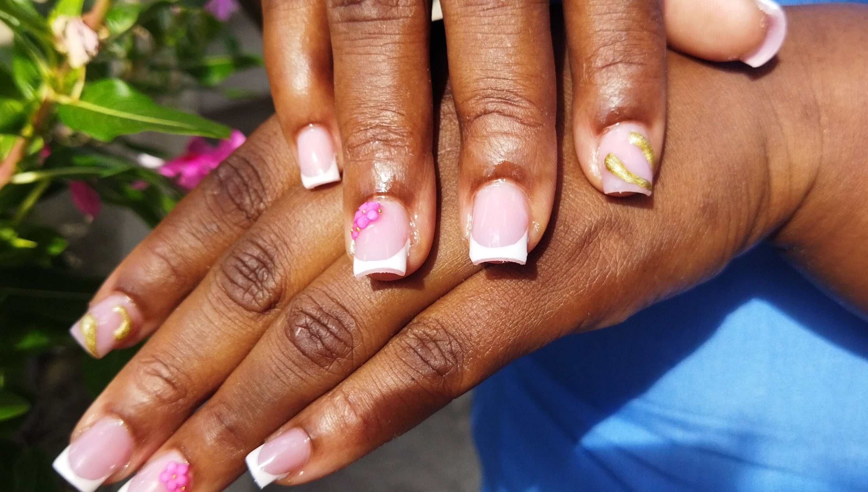 Elegant floral French manicure at Nail Therapy, Laborie, Laborie, LC. Beautiful pink nails with artistic accents.