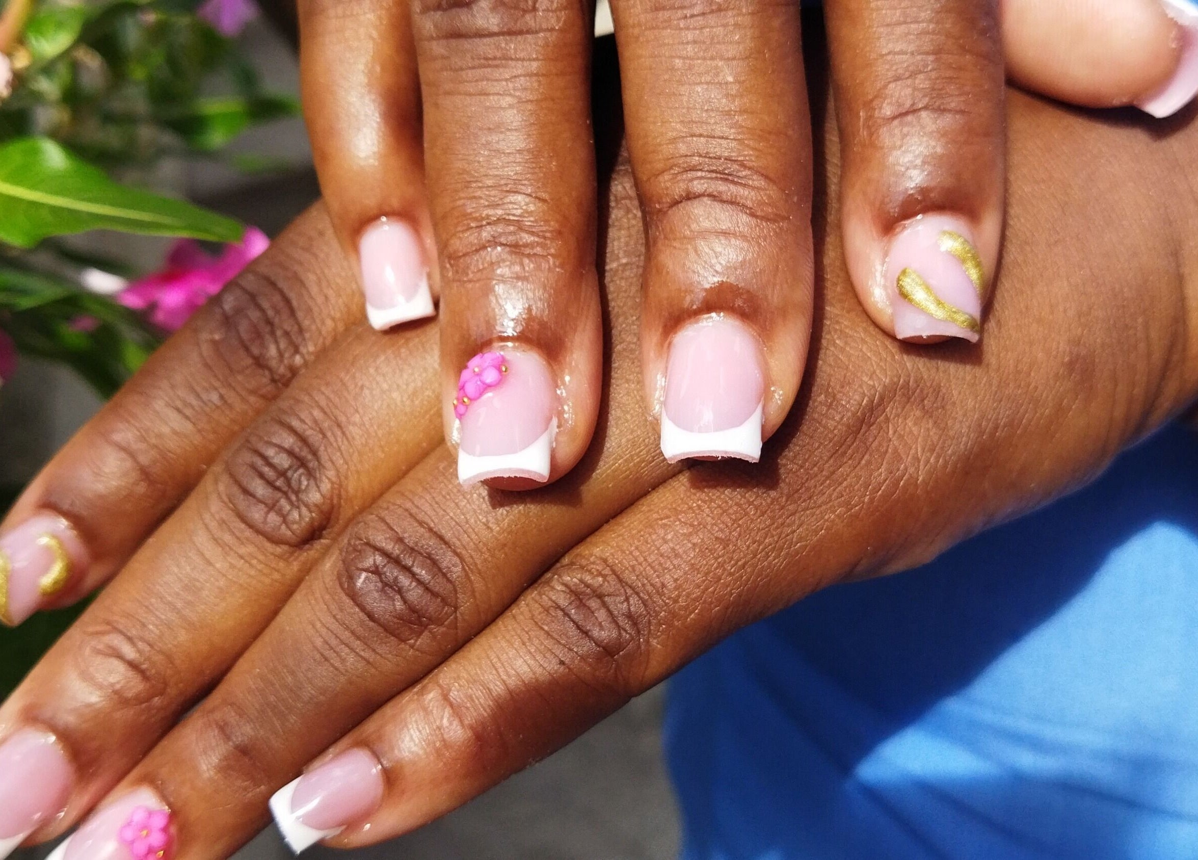Elegant floral French manicure at Nail Therapy, Laborie, Laborie, LC. Beautiful pink nails with artistic accents.
