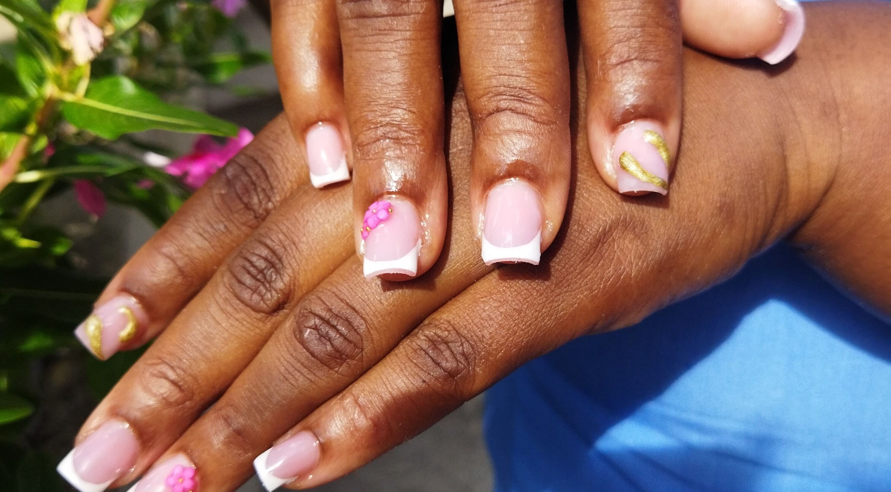 Elegant floral French manicure at Nail Therapy, Laborie, Laborie, LC. Beautiful pink nails with artistic accents.