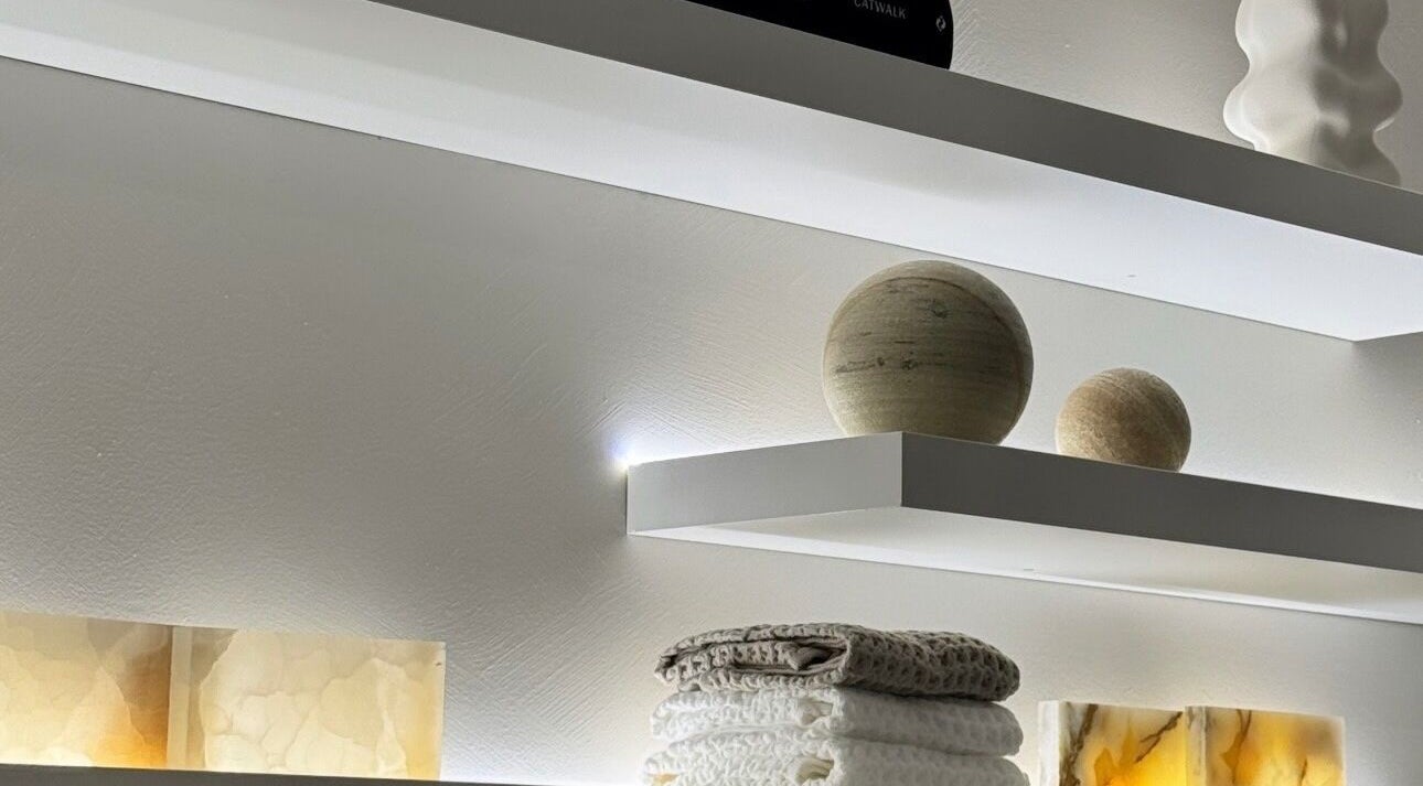 Elegant shelf with soft lighting and decor at E Lash Atelier, Merrylands West, New South Wales, AU.