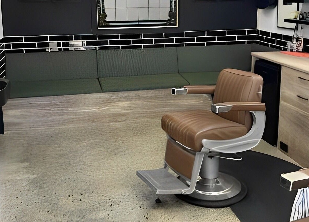 Spacious interior of Broken Hearts Barbershop in Port Macquarie, New South Wales. Modern barber chair and decor.
