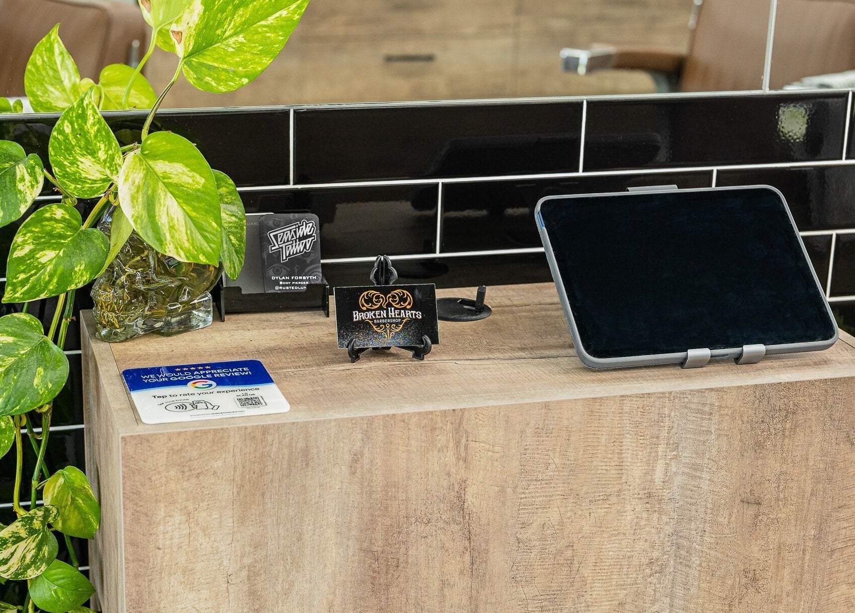 Modern counter at Broken Hearts Barbershop in Port Macquarie, New South Wales, with lush plant decor.
