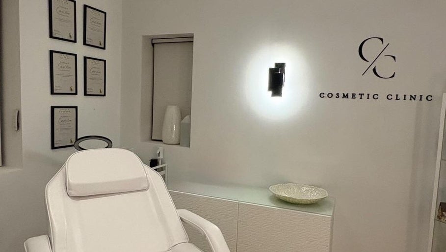 Modern treatment room at Cosmetic Clinic, Calverley, England, GB, with elegant decor and certification frames.