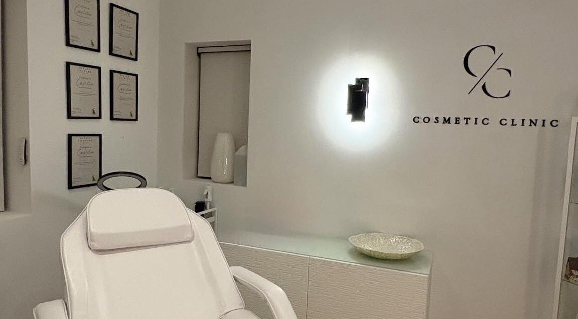 Modern treatment room at Cosmetic Clinic, Calverley, England, GB, with elegant decor and certification frames.