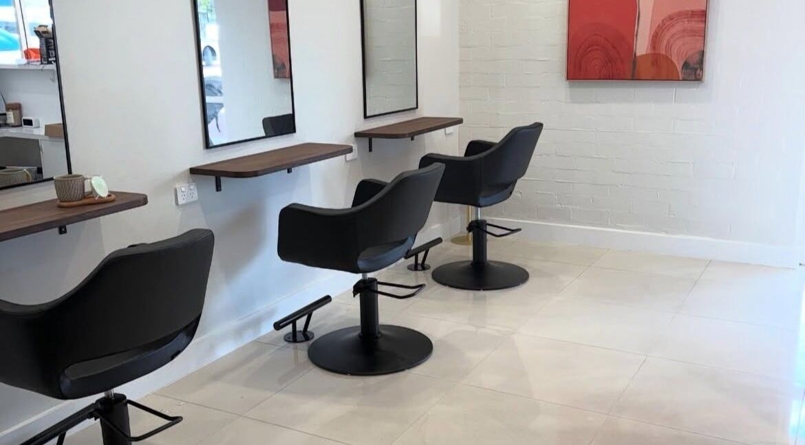 Modern salon interior at Gemma Gracie Hair Artistry in Applecross, Western Australia, AU with stylish black chairs.