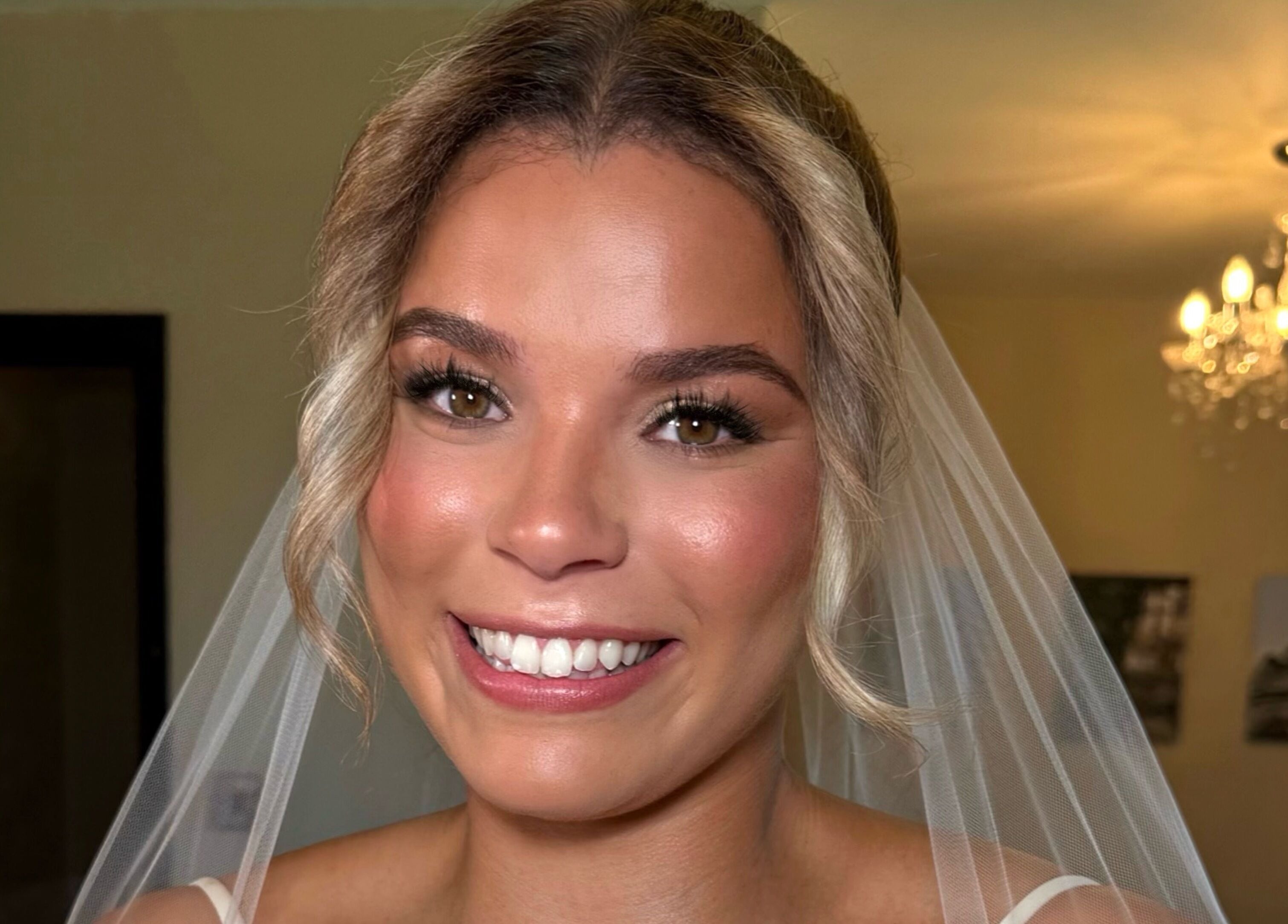 Beautiful bridal makeup by Olivia Caetano Make-up Artist in Bromley, England, GB. Radiant smile and stunning look.