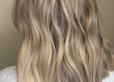 Soft blonde waves styled at Hannah Cox Hair, Reading, England, GB depict elegance and expertise.
