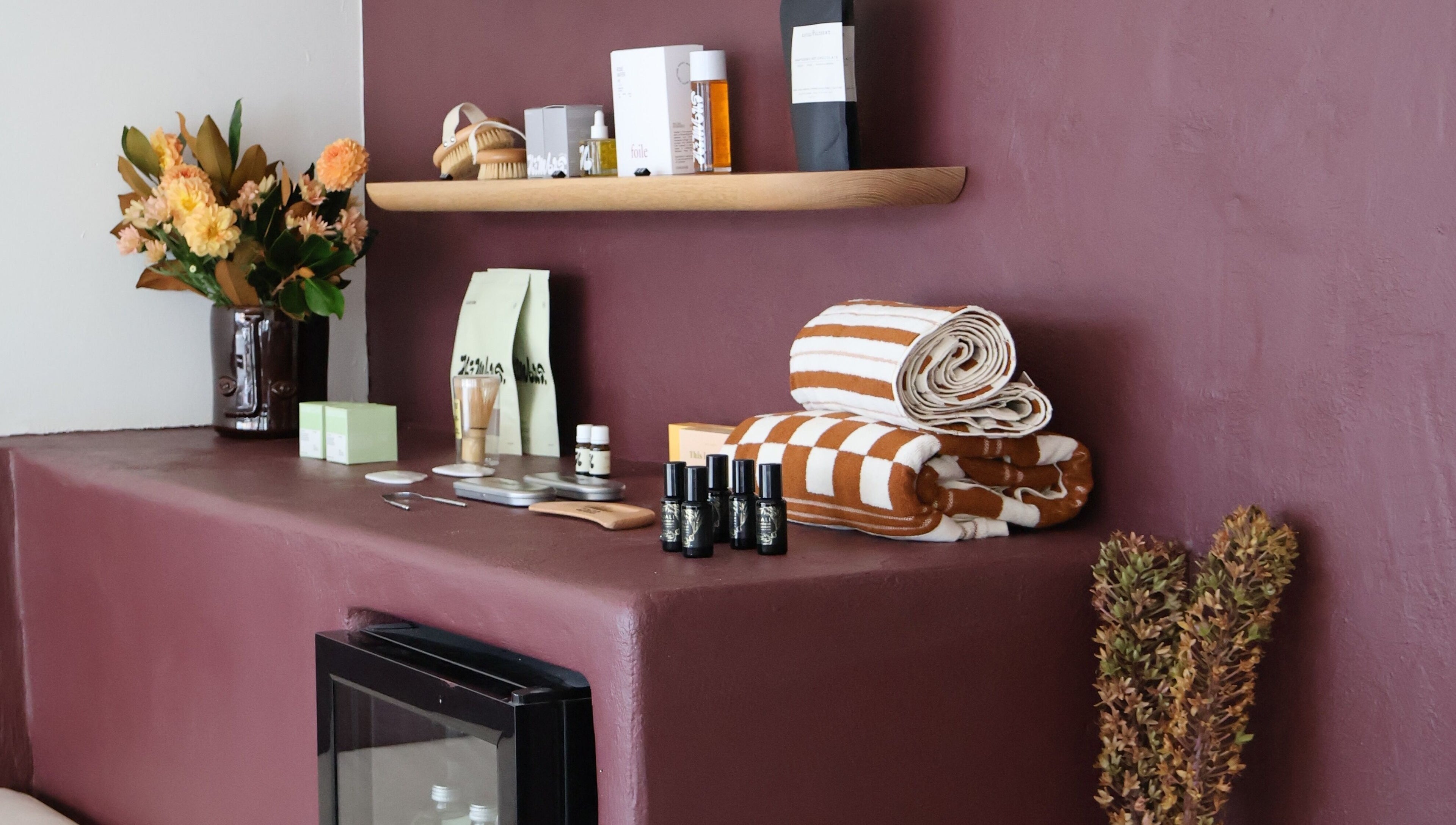 Nimbus Co Queenscliff displays wellness essentials in Manly, New South Wales, AU with towels and skincare items.