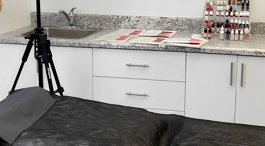 Professional PMU workspace at Miss Kris PMU, Toronto, Ontario, CA with ink bottles and tools organized.