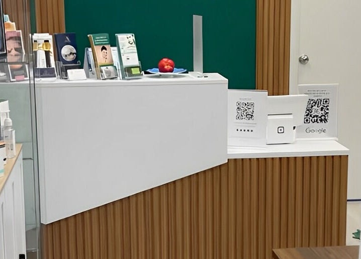 Reception area of Miss Kris PMU in Toronto, Ontario, CA, featuring modern decor and colorful brochures.