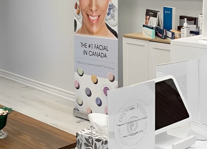 Reception area at Miss Kris PMU in Toronto, Ontario, CA with a modern setup and facial service banner.