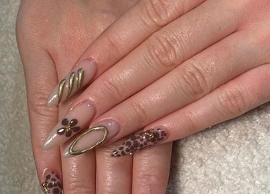 Elegant nail art with gold and floral designs at Billionhairs Lounge Beauty Salon, Doha, Doha Municipality, QA.
