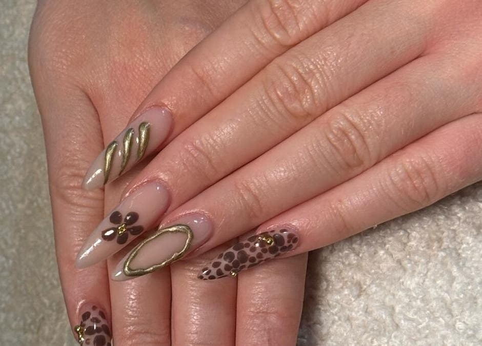 Elegant nail art with gold and floral designs at Billionhairs Lounge Beauty Salon, Doha, Doha Municipality, QA.