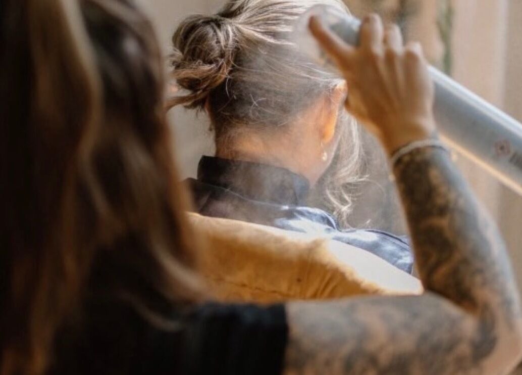 Expert hair styling with spray at HairbyAmiEileen in Basingstoke, England, GB. Creating elegant looks.