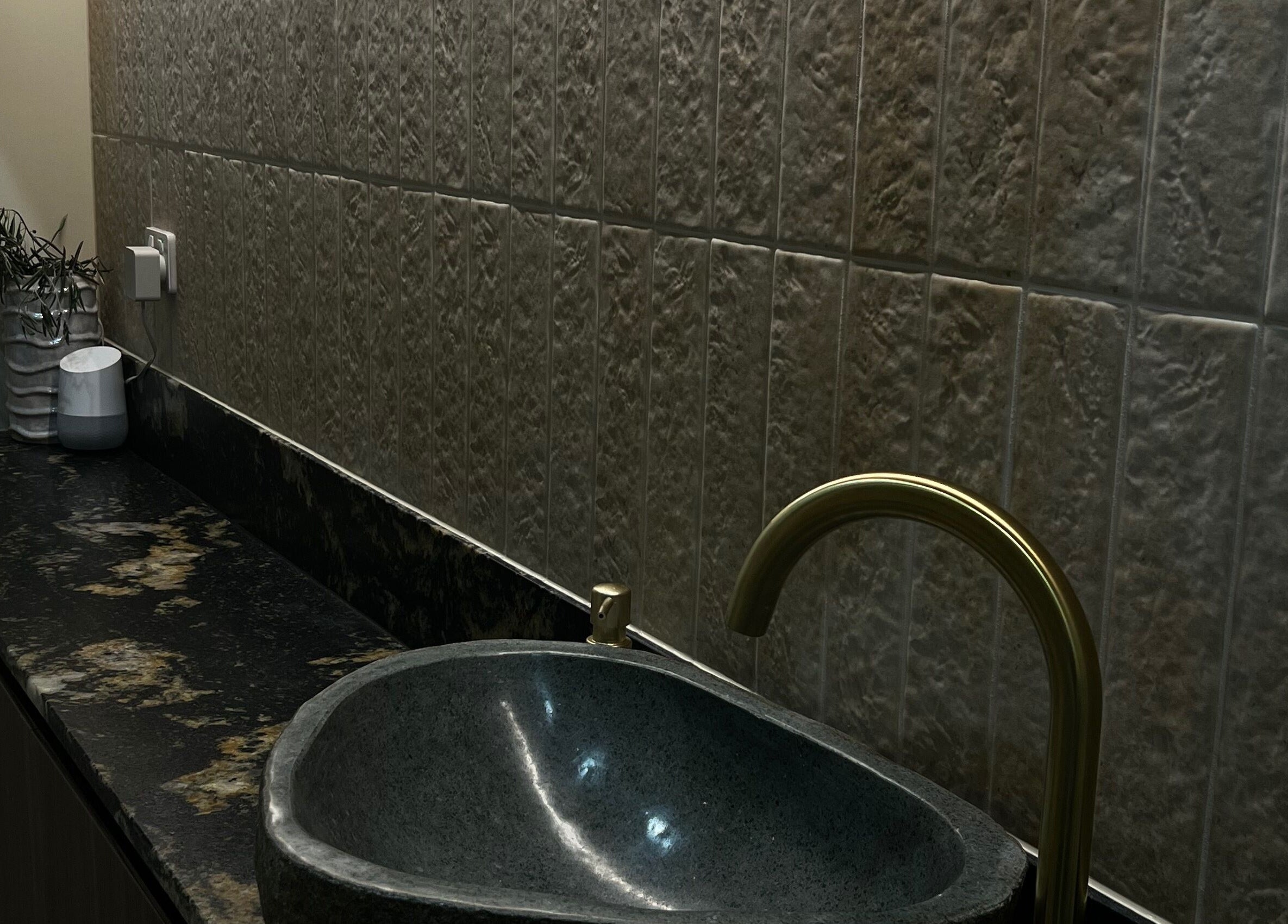 Elegant washbasin setup at The Dermal Den in Northcote, Victoria, AU with sleek dark countertop.