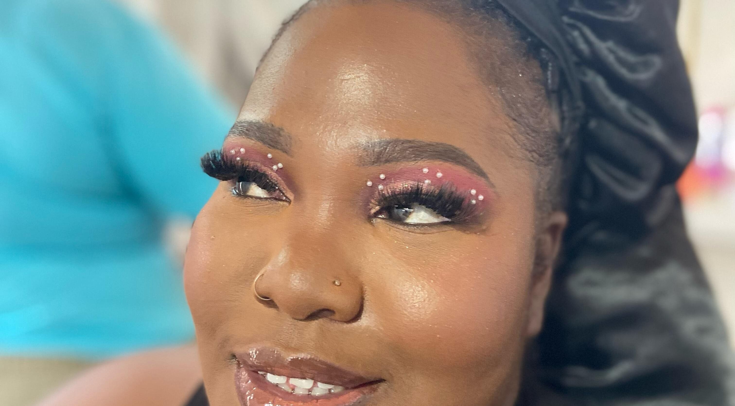 Close-up of elegant eye makeup with gems at Jibeautyplus, Roseau, Saint George Parish, DM.