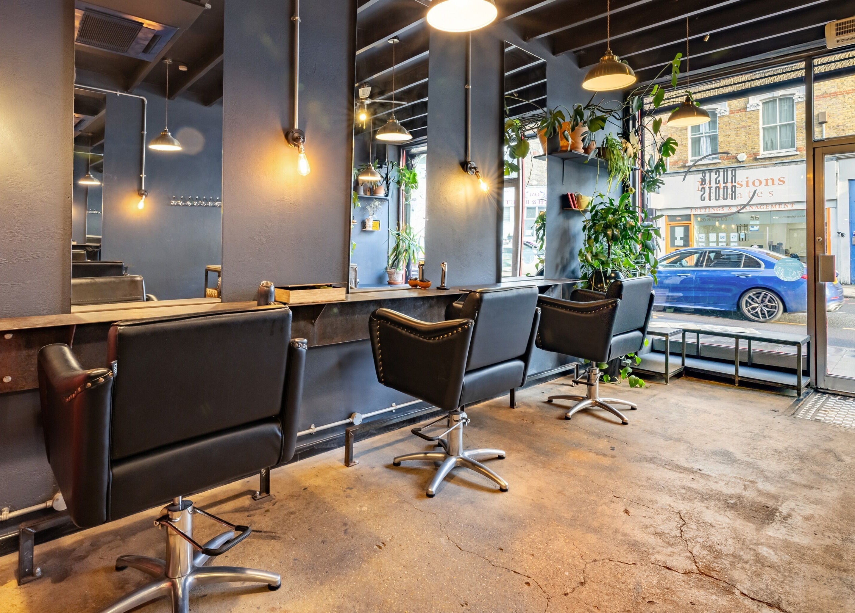 Chic interior of Rust & Roots salon in London, England, GB, featuring stylish chairs and modern decor.